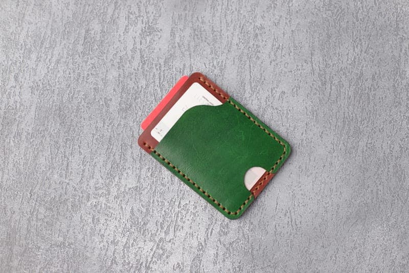 A slim leather wallet with cards fanned out