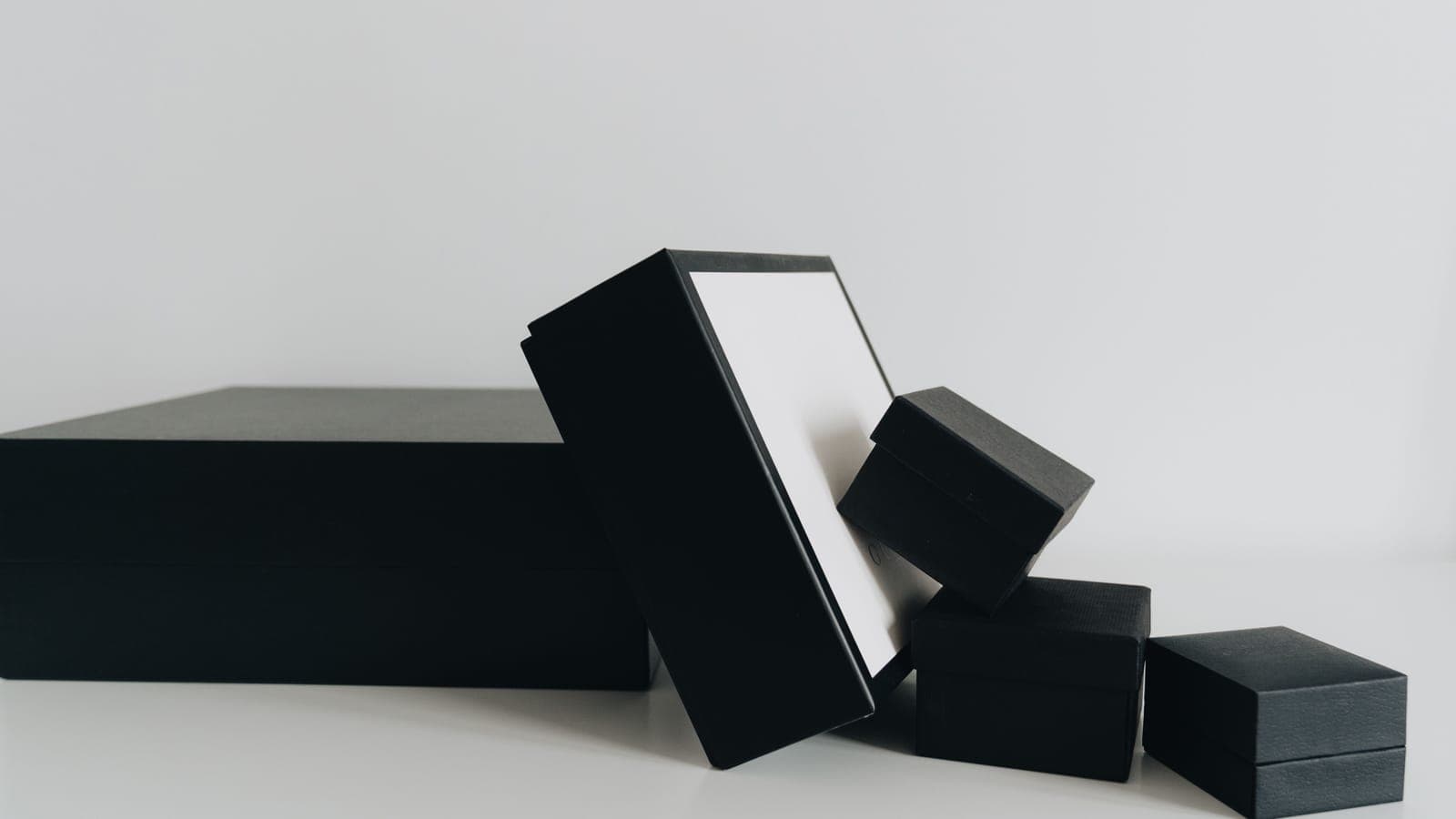Plain gift boxes stacked against a neutral background
