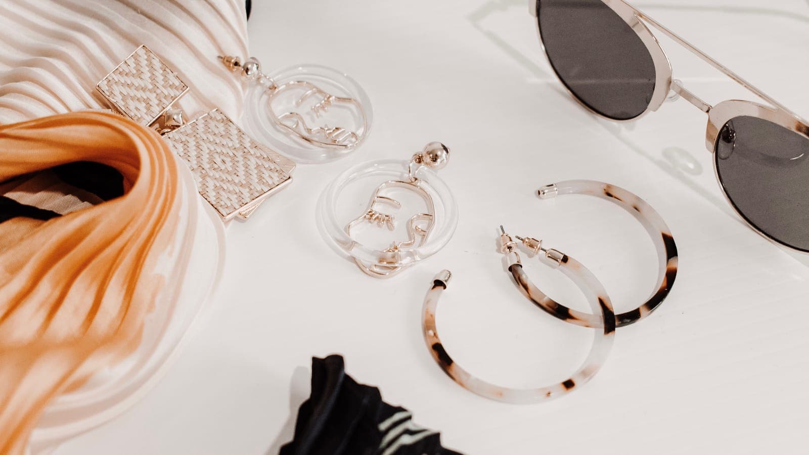 Flat lay of women's accessories and small jewelry pieces