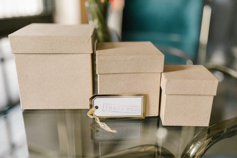 A small gift wrapped in brown paper