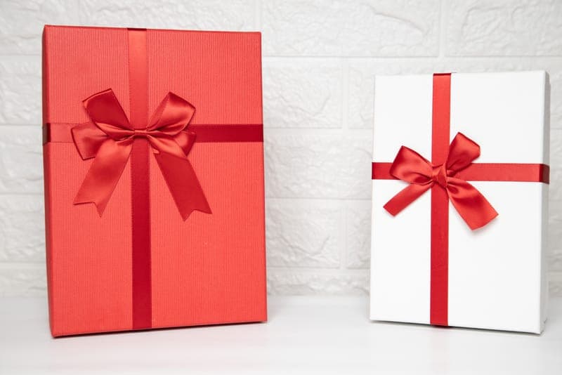 A simple white gift box with a ribbon